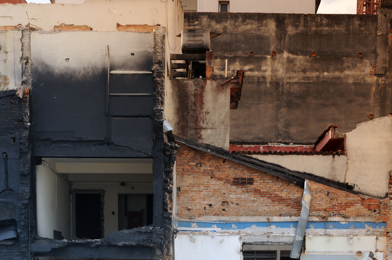 Uma fotografia de escombros, cujas marcas revelam o espectro de antigas paredes que antes existiam no ambiente
